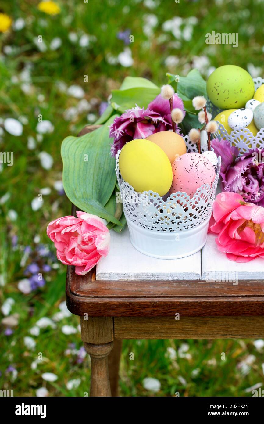 Easter table decoration with tulips and colorful eggs. Festive time Stock Photo