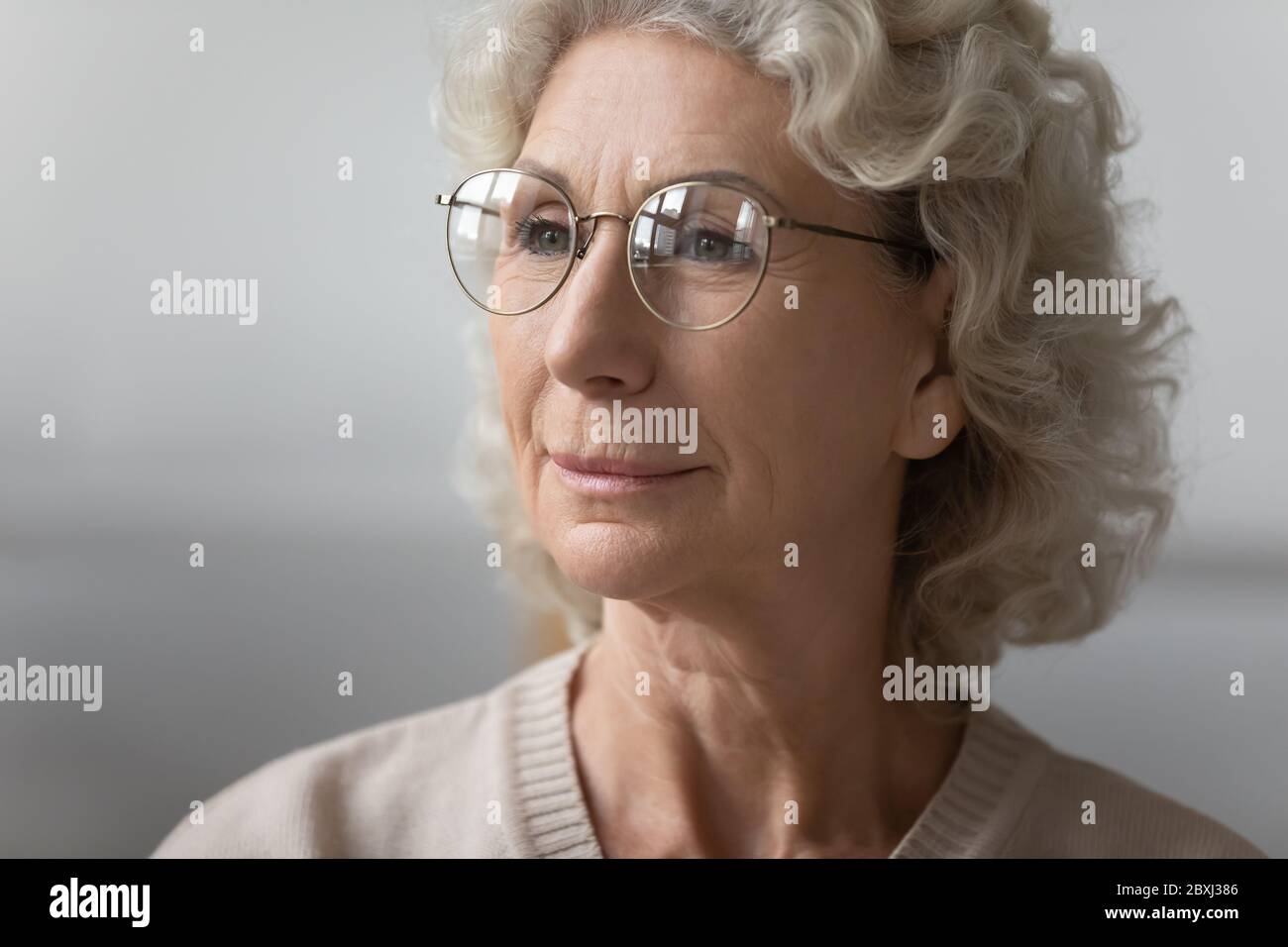 Close up of mature woman wearing modern round glasses Stock Photo