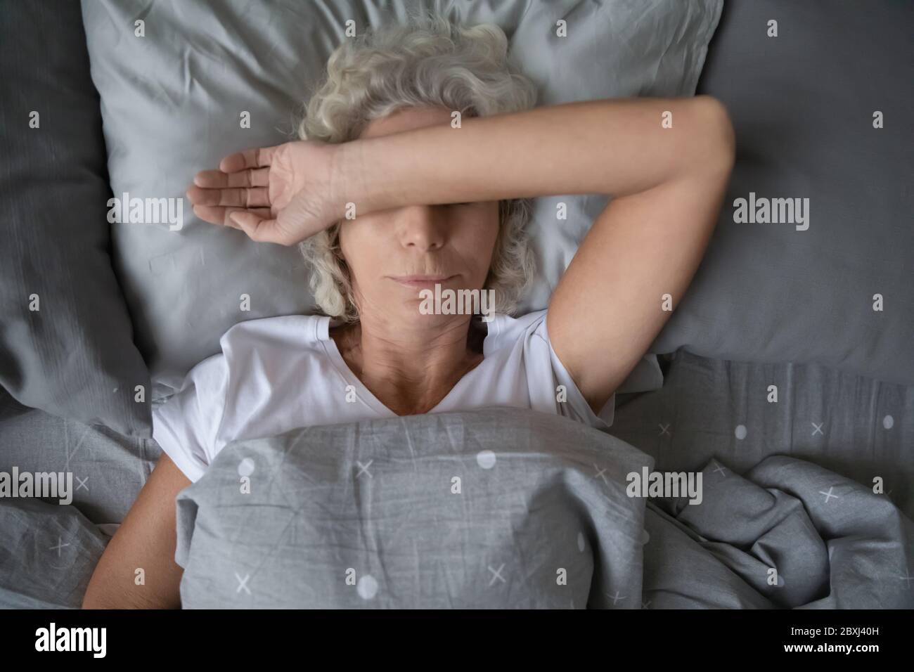 Tired female senior sleeping hi-res stock photography and images - Alamy