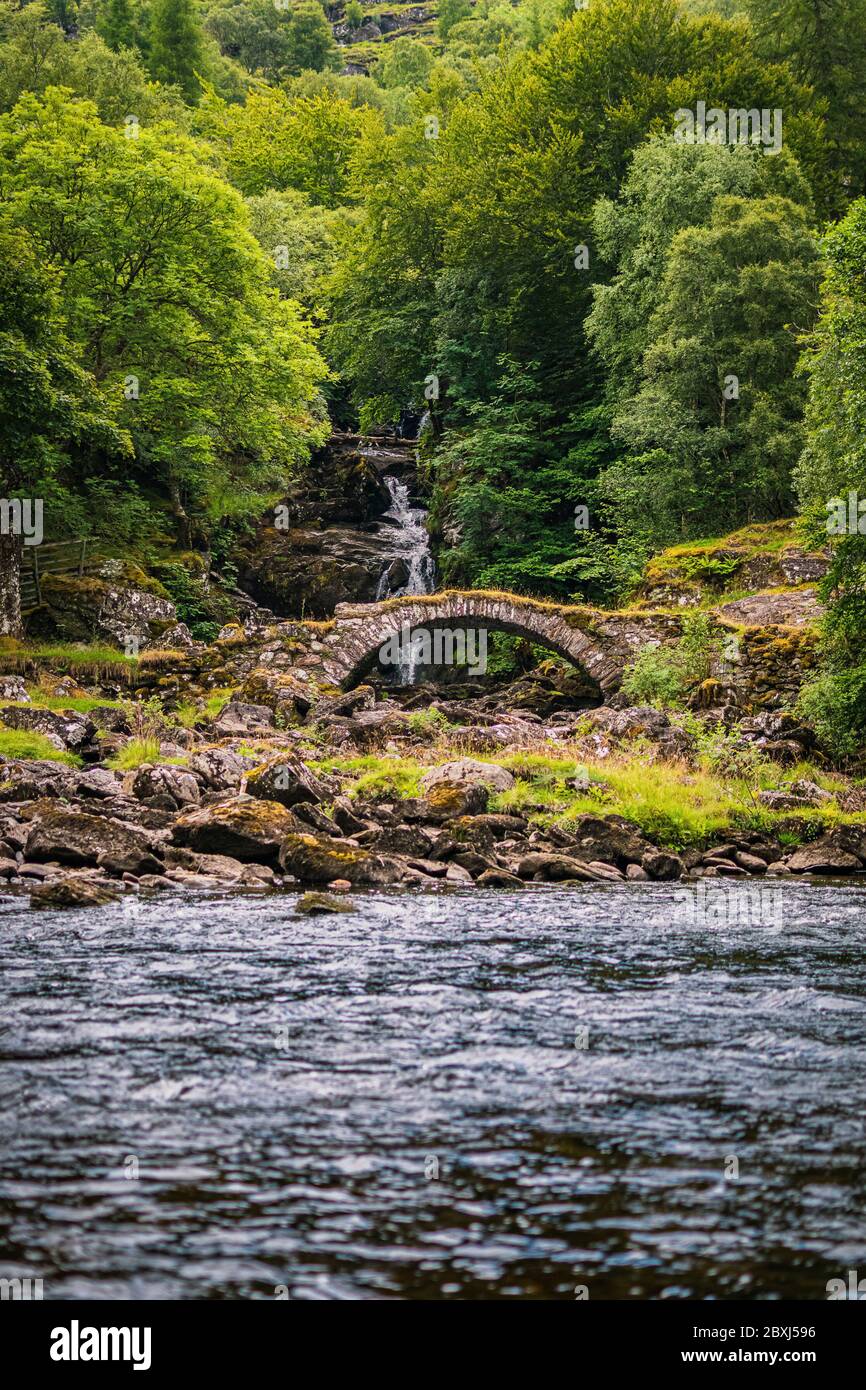 Charming stone 'Roman Bridge' in Glen Lyon, Perthshire, Scotland. beautiful summer Scottish Higlands landscape. Stock Photo