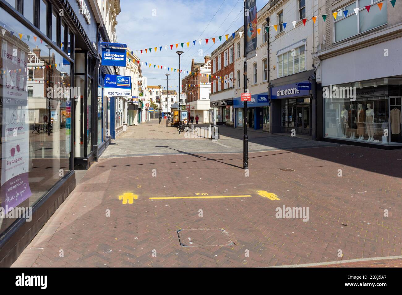 Worthing, Sussex, UK; 7th June 2020; Painted Sign on Pavement of Empty Town Centre Pedestrian Precinct Showing 2 Metres For Social Distancing Stock Photo