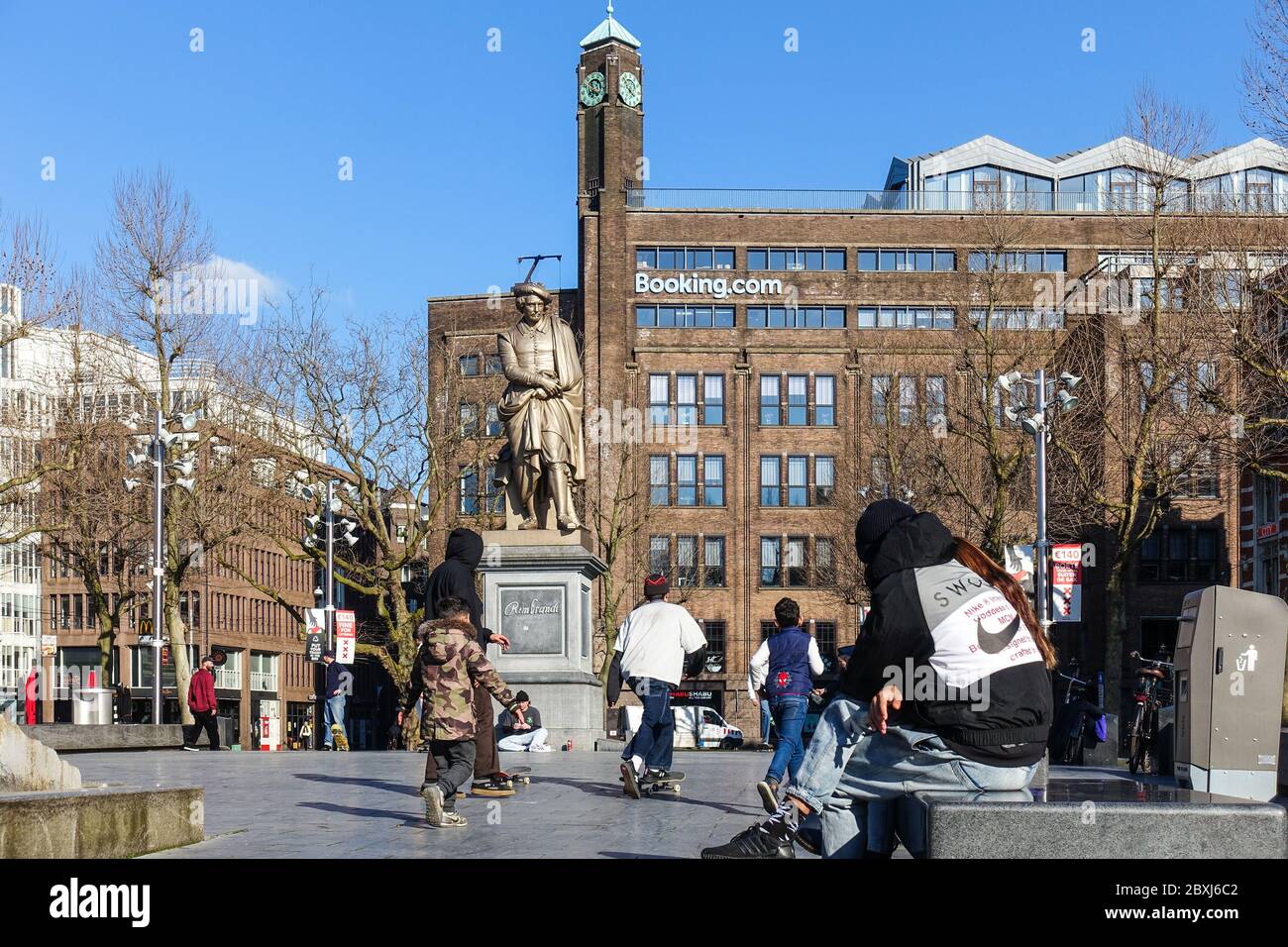 Booking.com headquarters on Rembrandtplein in Amsterdam, with skaters during the coronavirus crisis Stock Photo