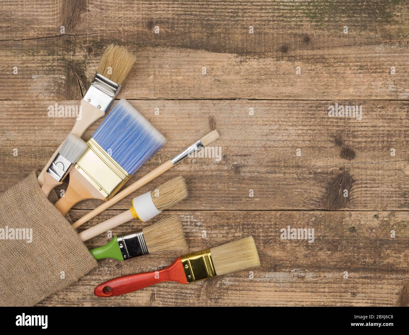 The brush of a painter to repair on wood background.. Painting supplies