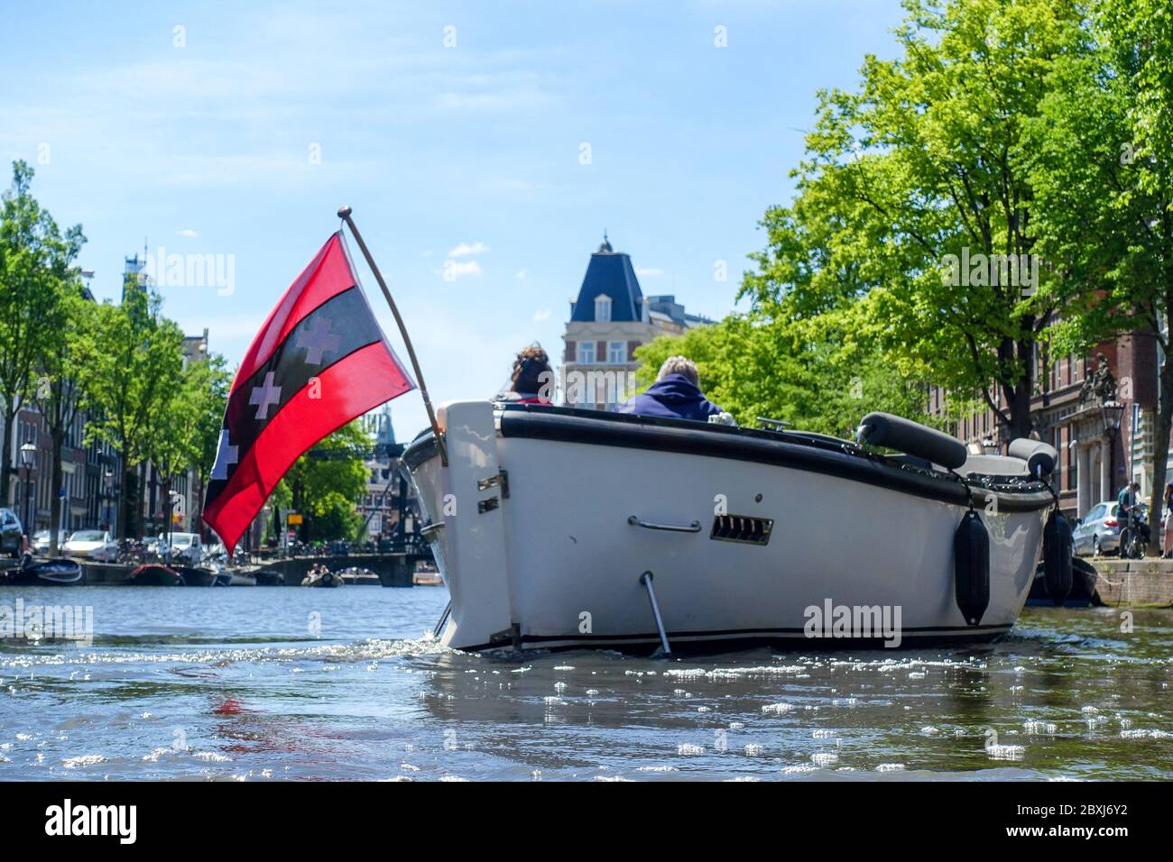 Quiet Amsterdam (Netherlands) during the Covid-19 crisis, views of the empty red light district and a boat showing the XXX Amsterdam flag Stock Photo