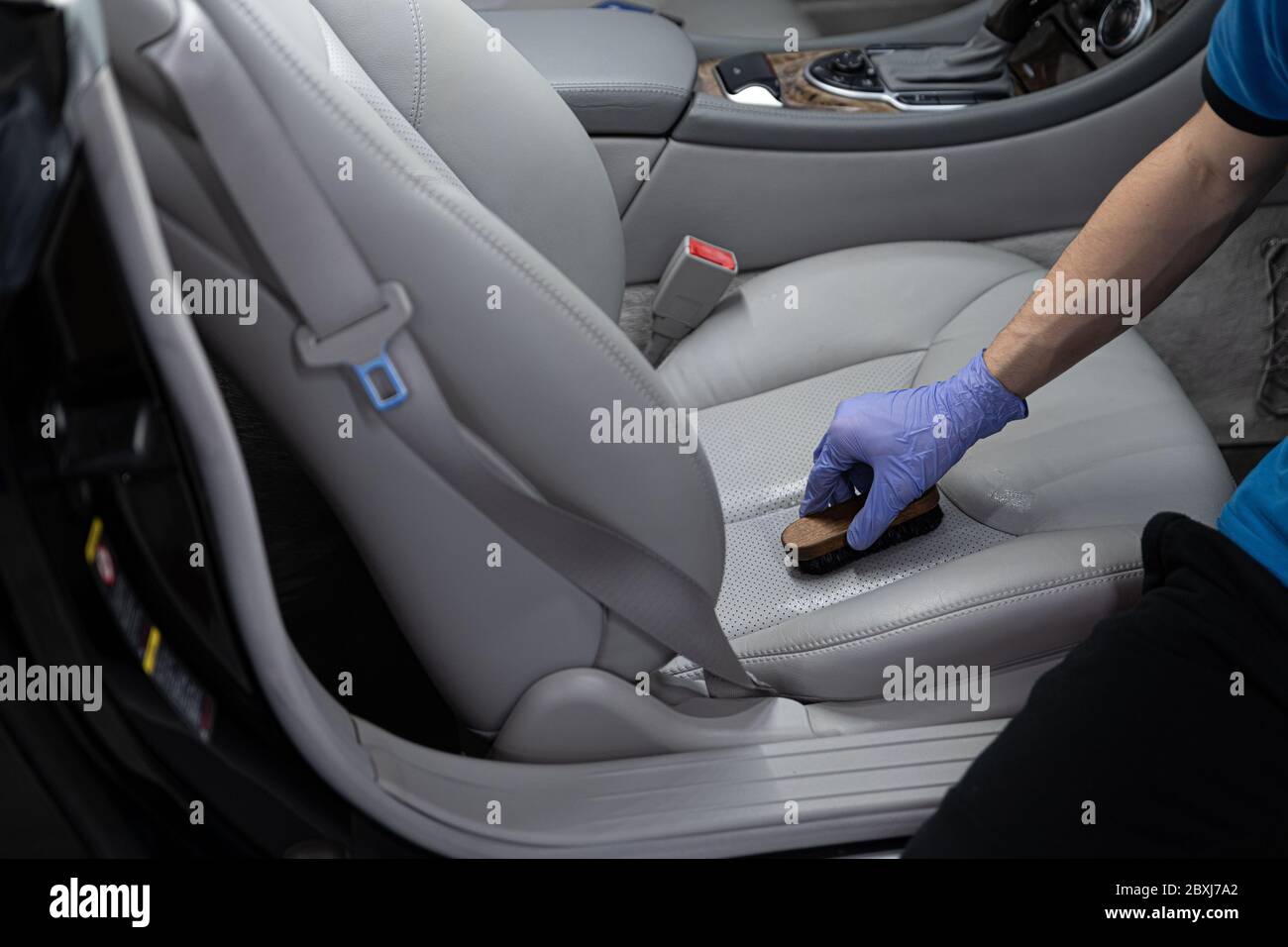 Car detailing studio worker cleaning car leather seat Stock Photo Alamy