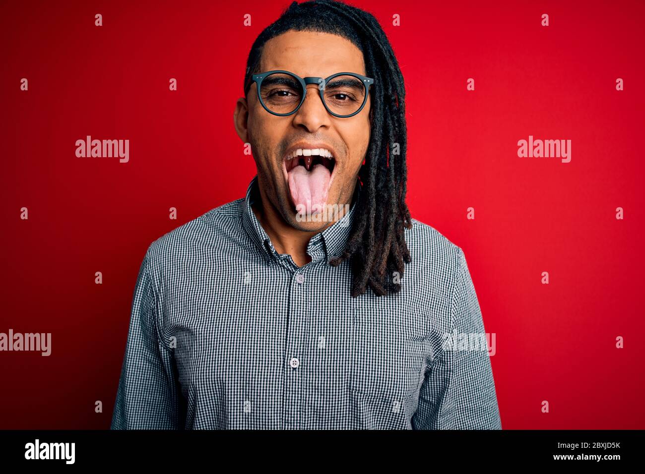 Young handsome african american man with dreadlocks wearing casual ...