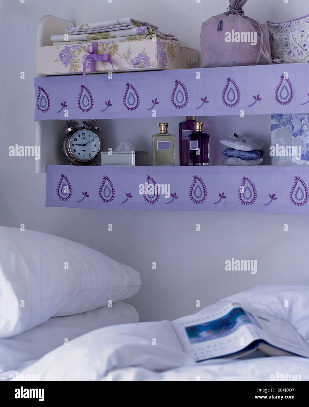 Decorated shelving next to bed Stock Photo Alamy