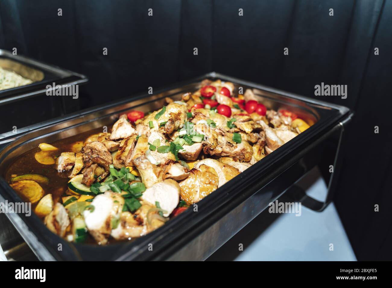 https://c8.alamy.com/comp/2BXJFE5/stainless-hotel-pans-on-food-warmers-with-various-meals-roasted-meat-pieces-with-vegetable-self-service-buffet-table-celebration-party-wedding-2BXJFE5.jpg