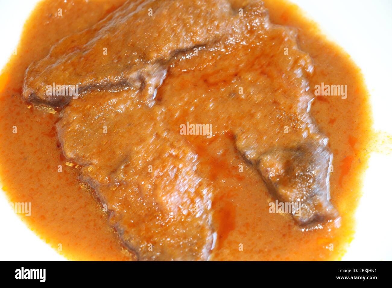 braised meat slices in the dish with sauce Stock Photo Alamy