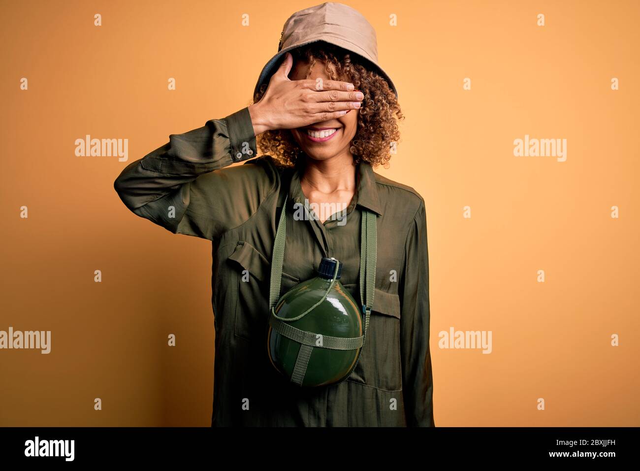 Young african american tourist woman on vacation wearing explorer hat ...