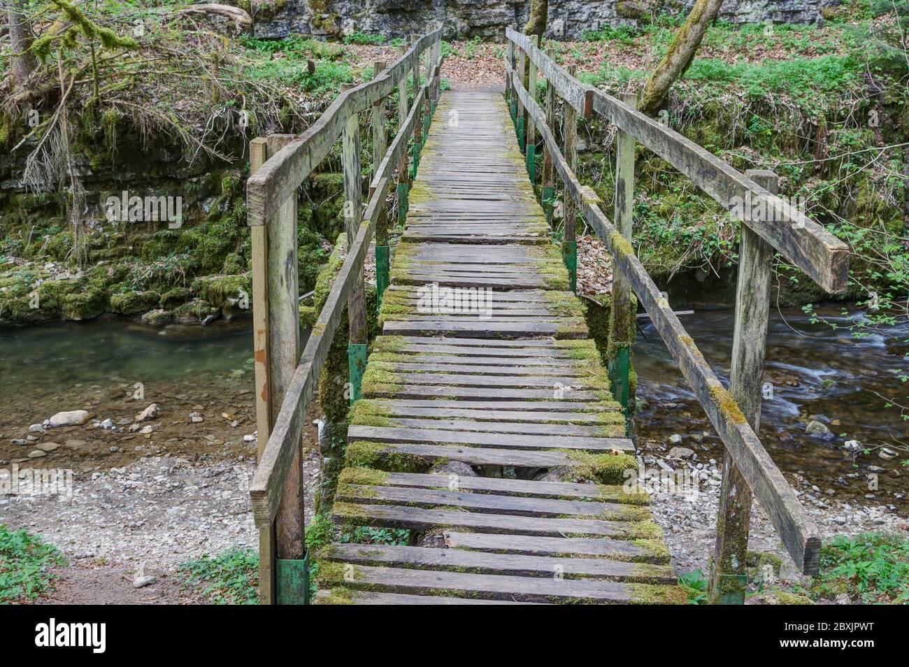 Wooden bridge over the river Gauchach in need of repair. Stock Photo