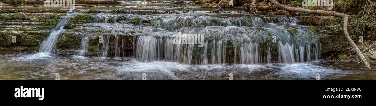 The Gauchach is a clear mountain stream and flows in troubled paths along rubble and moss-covered rock. Stock Photo