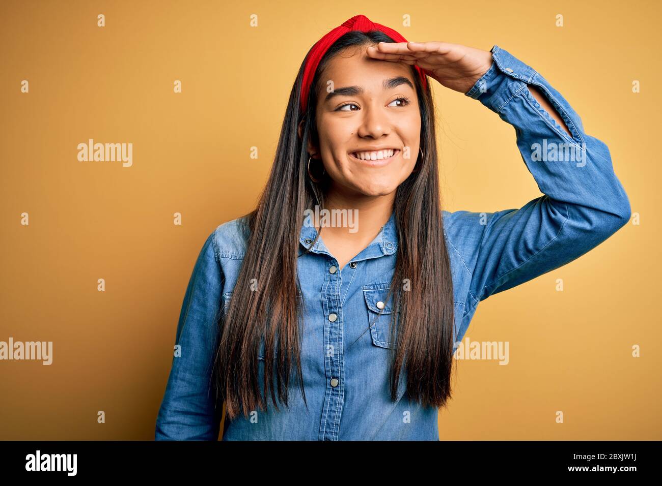 Young beautiful asian woman wearing casual denim shirt and diadem over ...