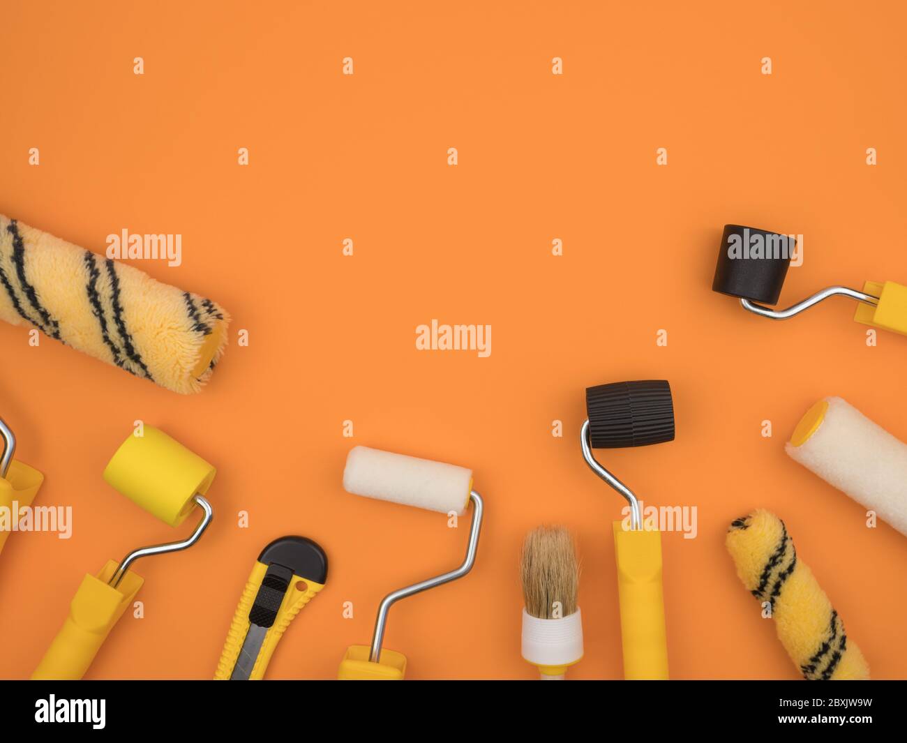Manual painting tools on orange background. A paint tool for Wallpaper