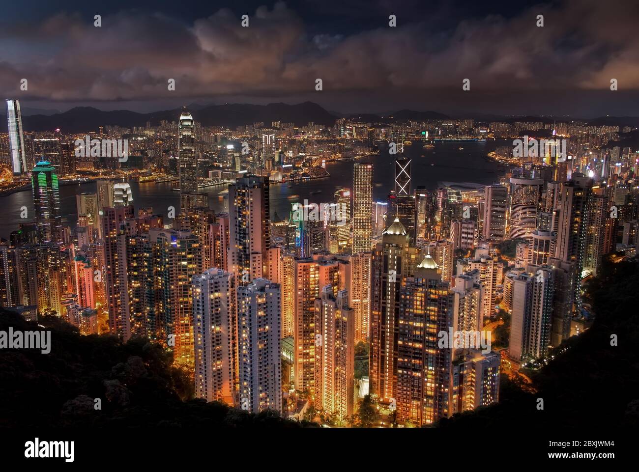 Iconic View from the Peak of Hong Kong and Kowloon City Skyline at Night Stock Photo