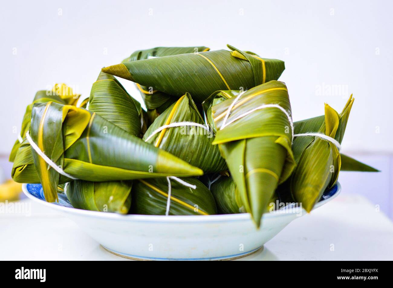 Zongzi Isolated against white background. Zongzi is the traditional Chinese rice dumplings for Dragon Boat Festival (Duanwu Festival). Stock Photo