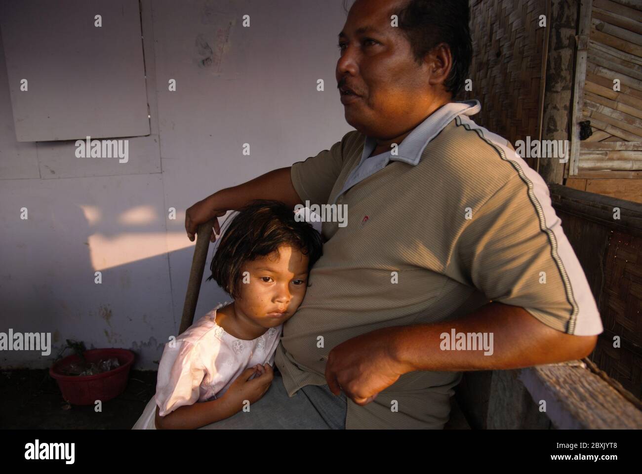 Portrait of a man while he tells story on how a coastal flood during bad weather once dragged him and a part of his wooden house which was located on the tidal area of Marunda fishing village in North Jakarta, Jakarta, Indonesia. Stock Photo