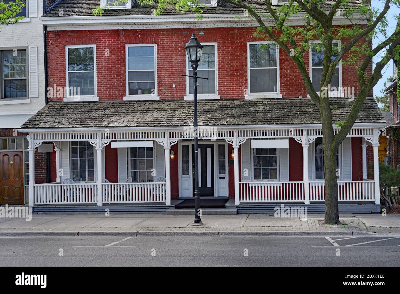small old  apartment building or hotel with full width porch Stock Photo
