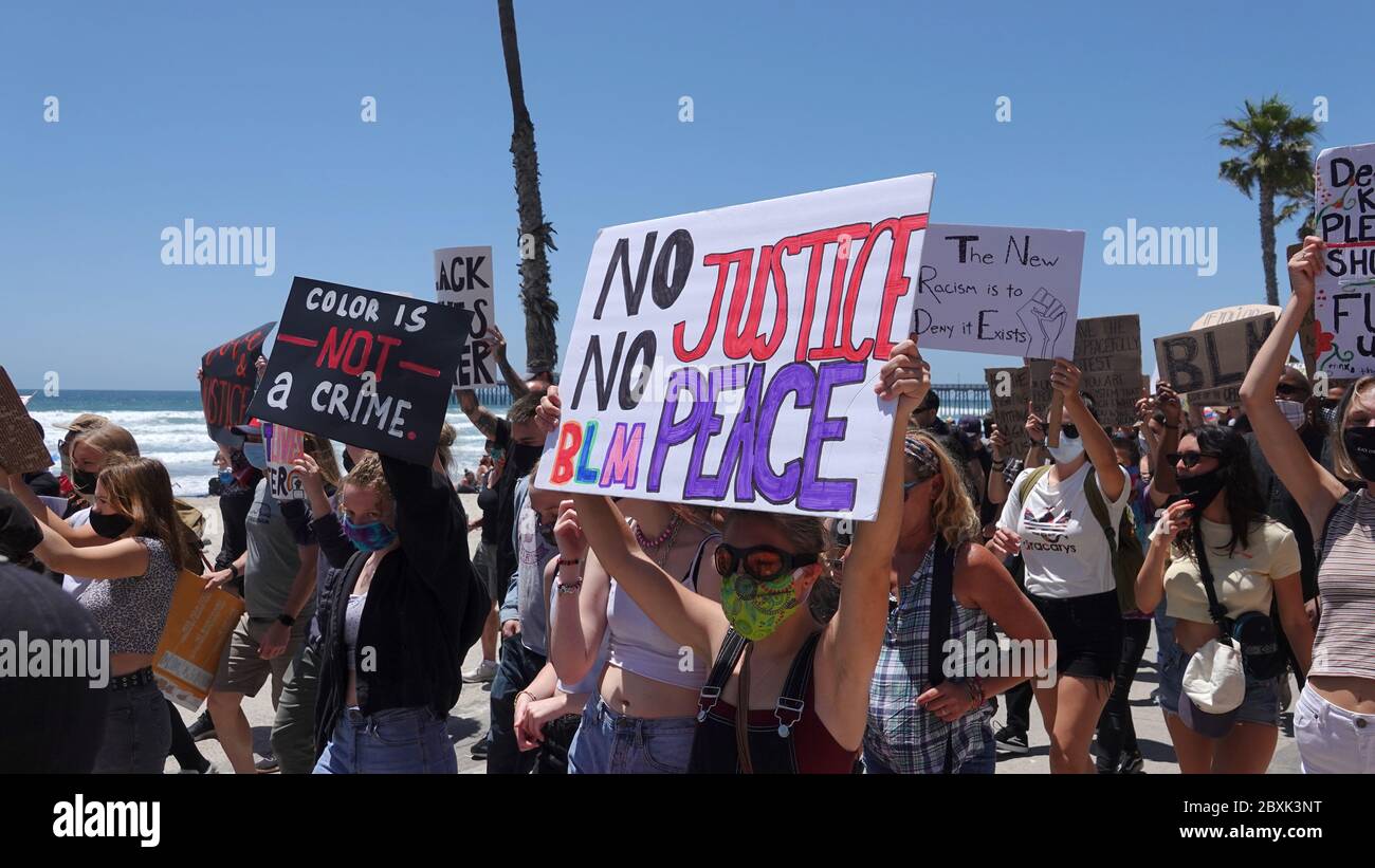 Oceanside, CA / USA - June 7, 2020: Protesters hold up a signs during a peaceful Black Lives Matter protest march in San Diego County. Stock Photo