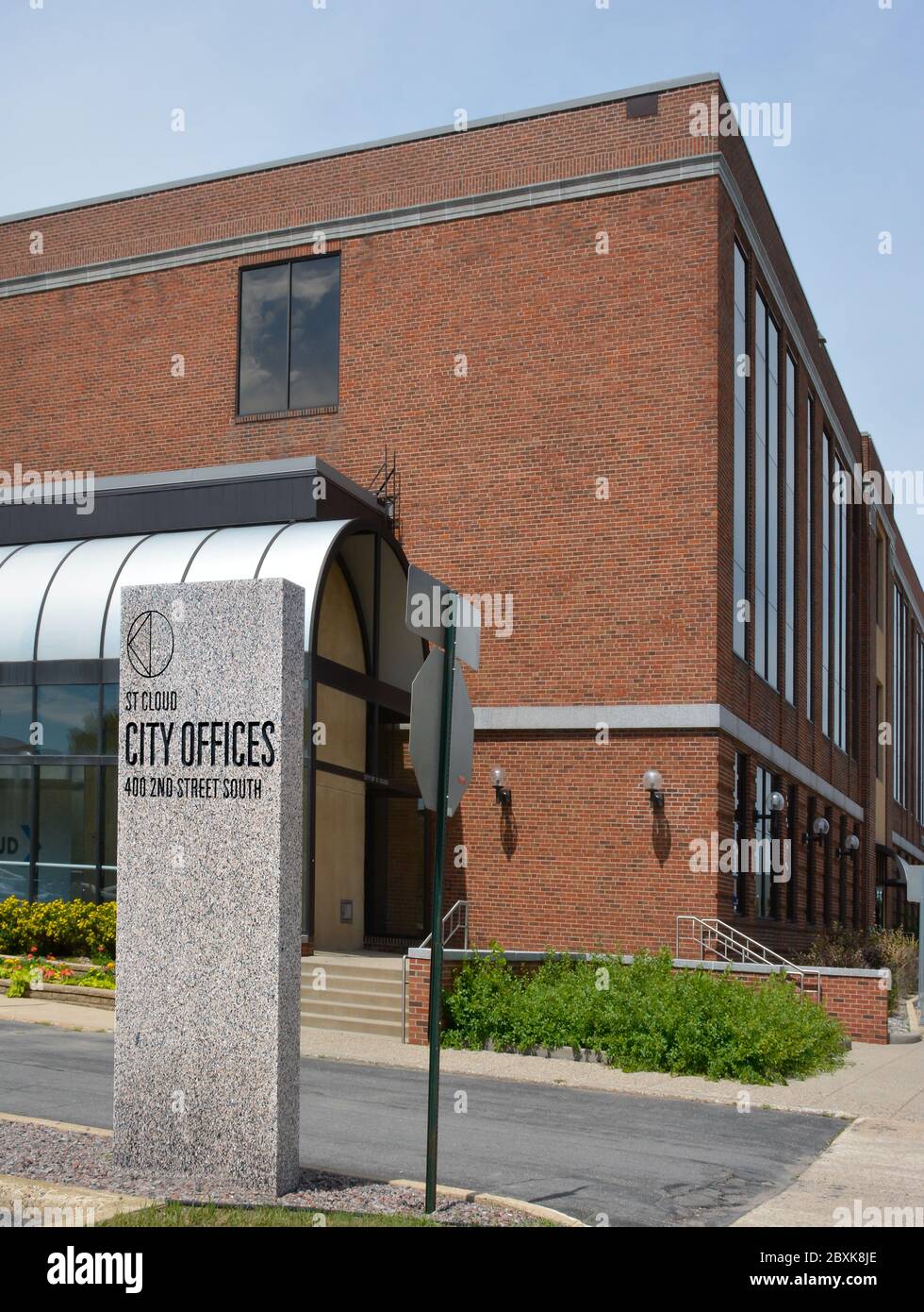 A modern brick City Hall government bulding with a marble sign for St