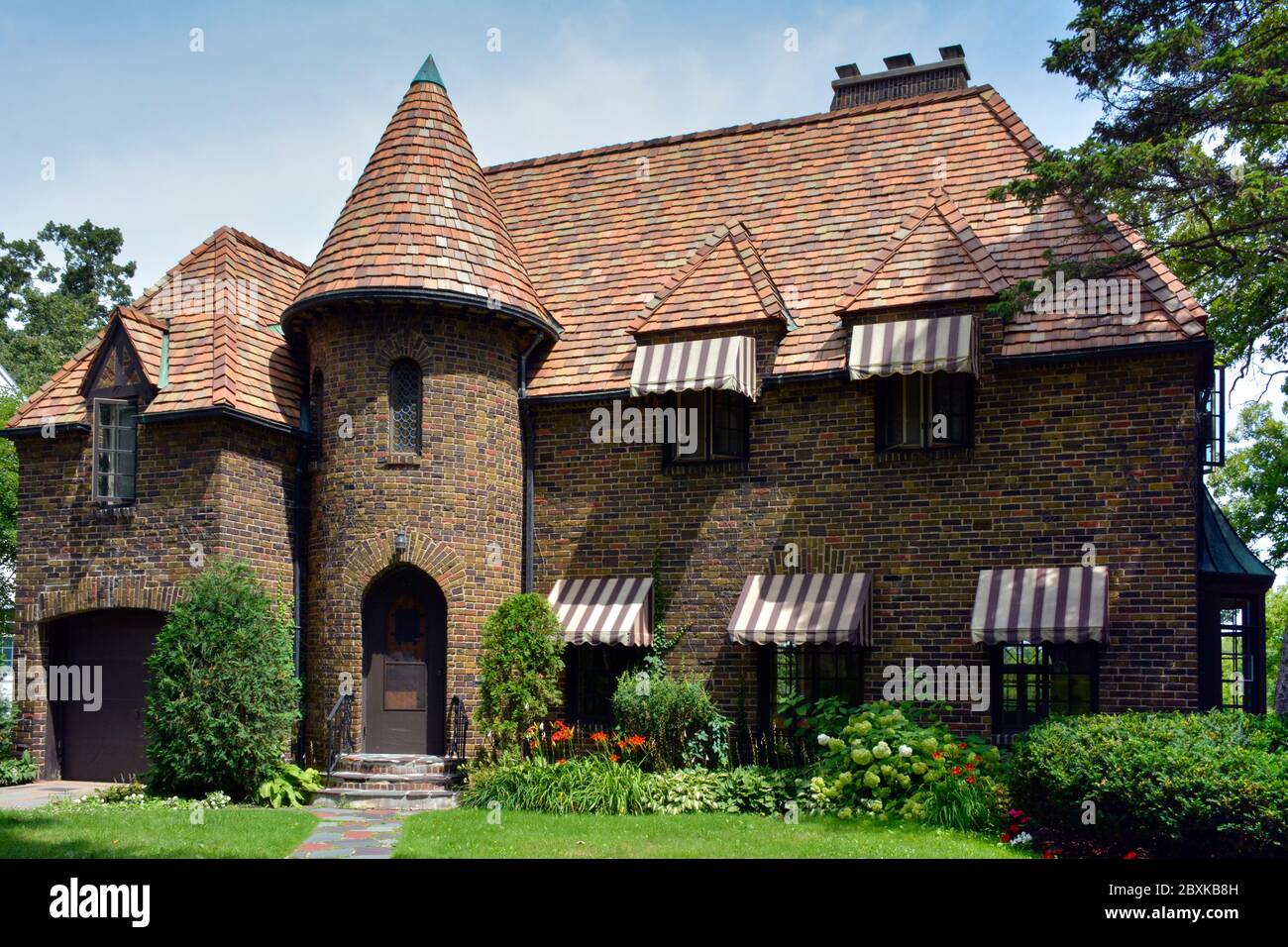 A stunning brick residence with French Norman and Tudor elements with turret and awnings, in the historic Southside neighborhood of St. Cloud, MN, USA Stock Photo
