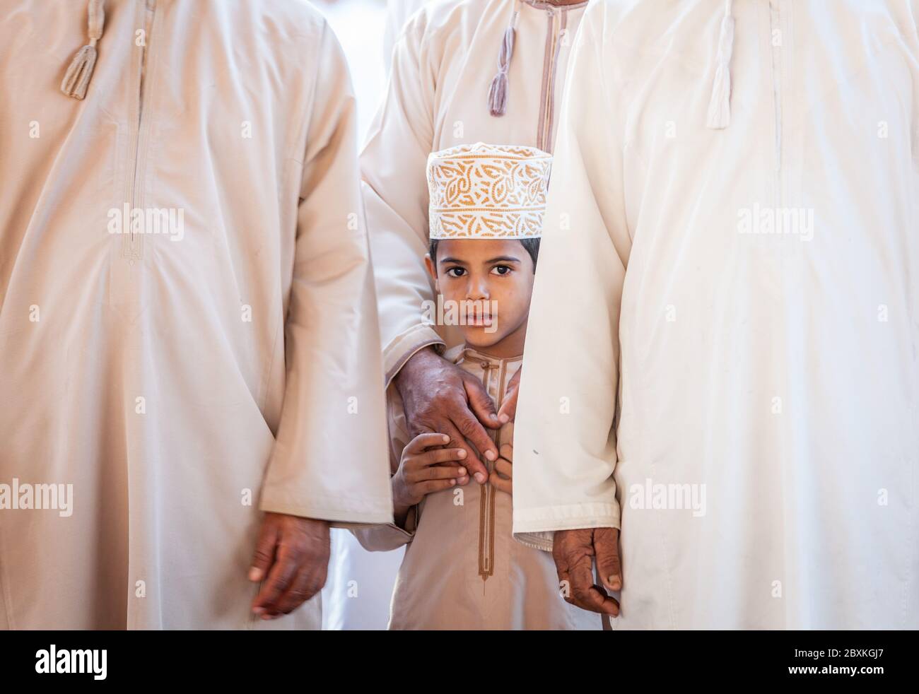 Nizwa, Oman, December 2, 2016: Portrait of a local boy in traditional clothes at the Friday goat market in Nizwa, Oman Stock Photo
