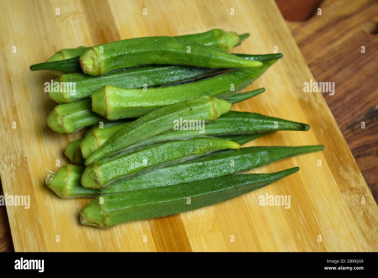 Lady Fingers or Okra Vegetable Over Wooden Table Background Stock Photo