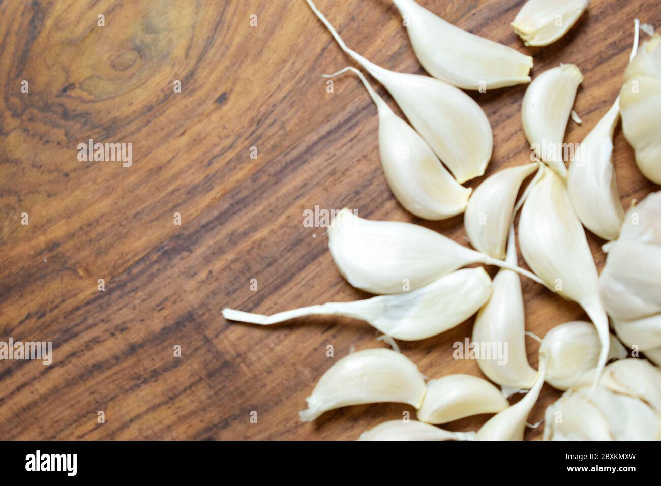 Garlic and Garlic Cloves on a Vintage Wooden Background Stock Photo - Alamy