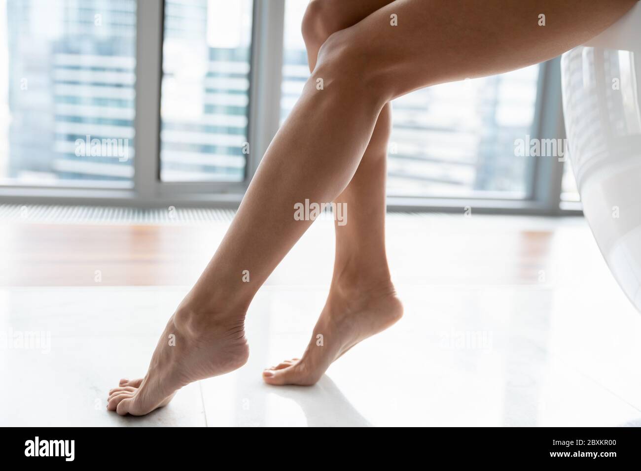 Close up young woman with beautiful legs sitting on bath Stock Photo ...