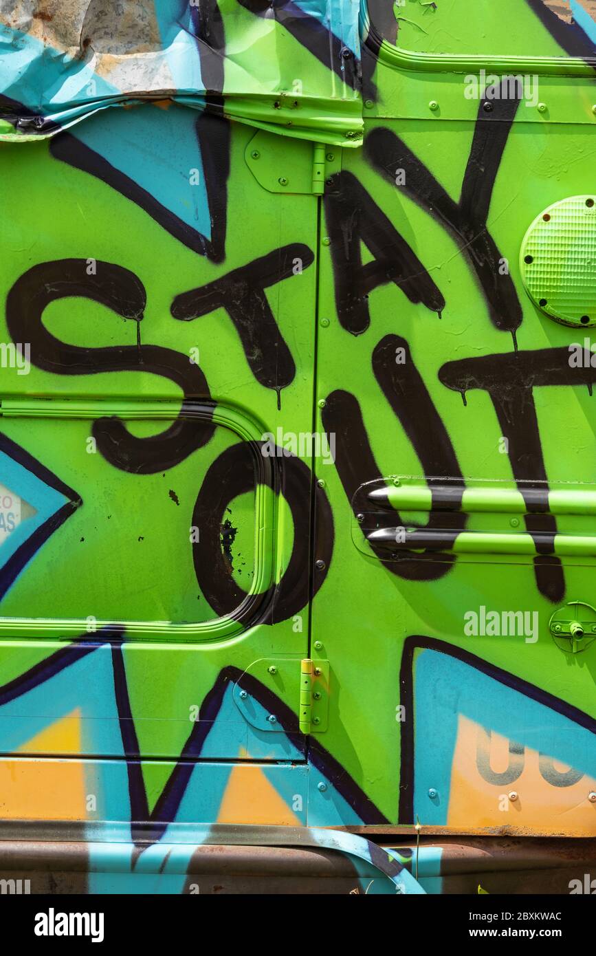 'Stay Out' graffiti message at the School Bus Graveyard in Alto, Georgia. (USA) Stock Photo