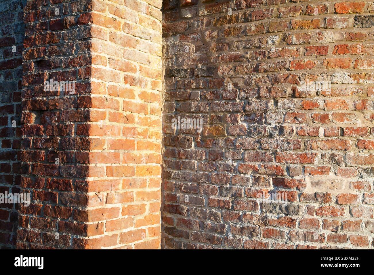 Old, weathered bricks in wall Stock Photo
