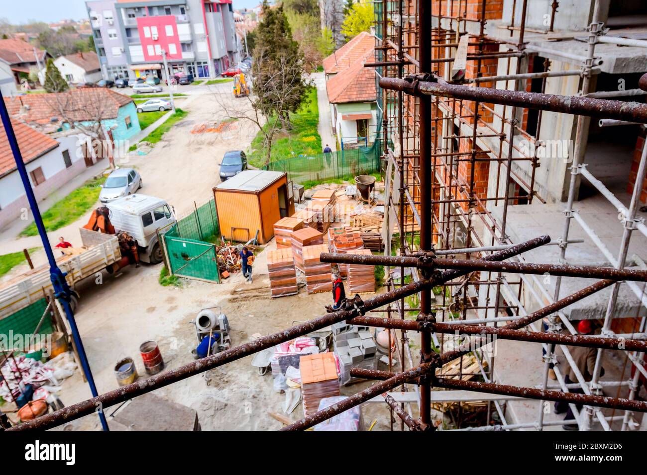 Rusty scaffold is placed against edifice, building under construction ...