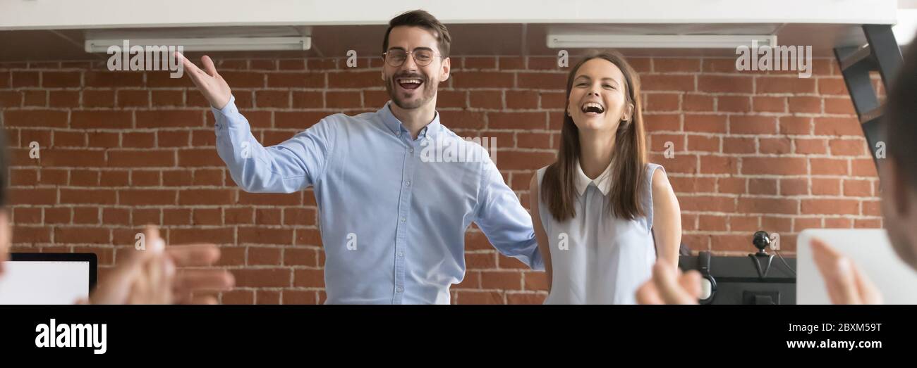 Company boss and staff welcoming new employee excited young woman Stock Photo