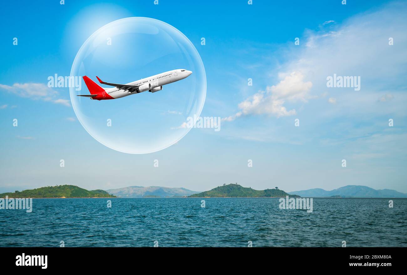 Travel bubble concept - Airplane traveling in bubble representing international travel bubble project to revive tourism and hotel industry among count Stock Photo