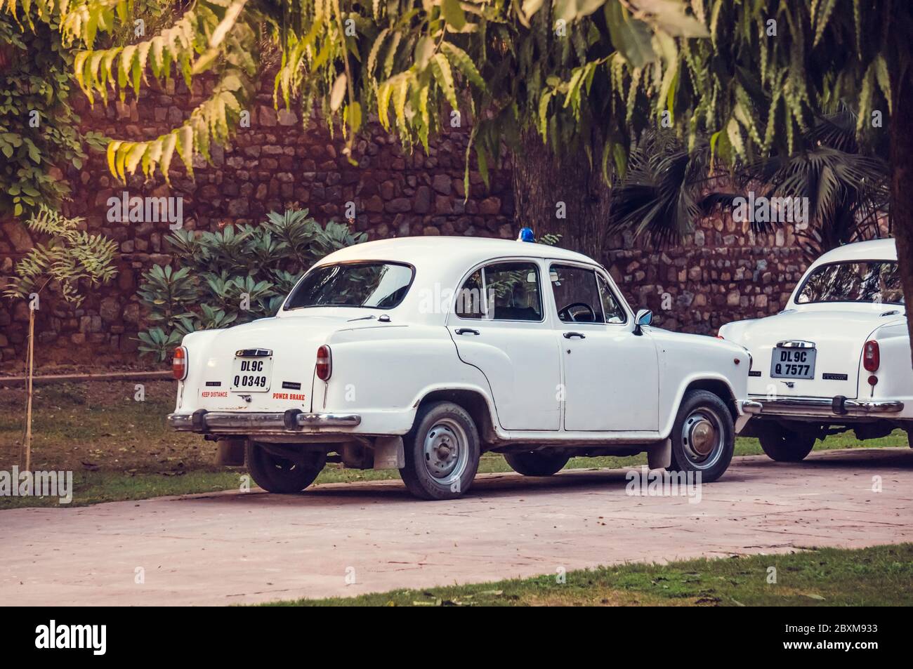 NEW DELHI, INDIA - 05 FEB. 2014 - White Indian retro cars parked in the territory of Red Fort - Lal Qila, one of the main landmarks in New Delhi Stock Photo