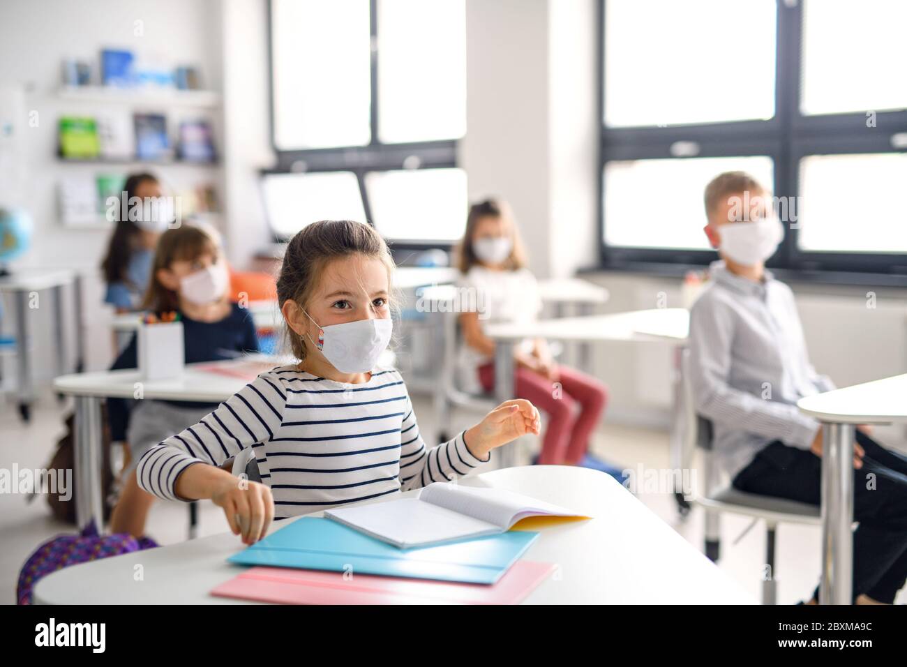 Children with face mask back at school after covid-19 quarantine and lockdown. Stock Photo