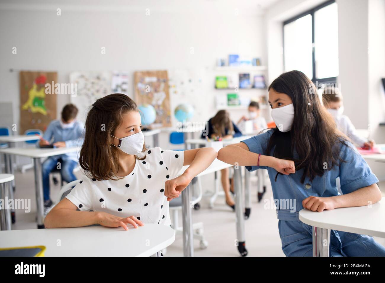 Children with face mask back at school after covid-19 quarantine and ...