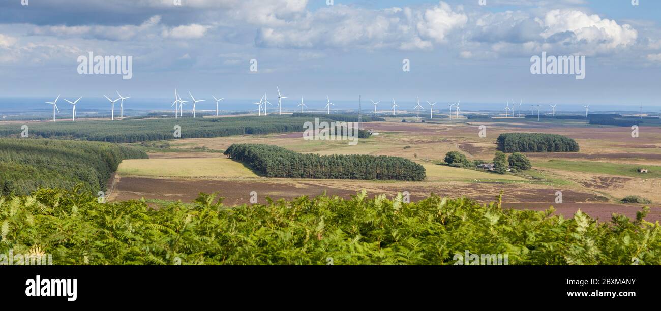 View towards the Northumberland coast from Ros Castle with the prominent wind turbines of Wandylaw and Middlemoor wind farms Stock Photo