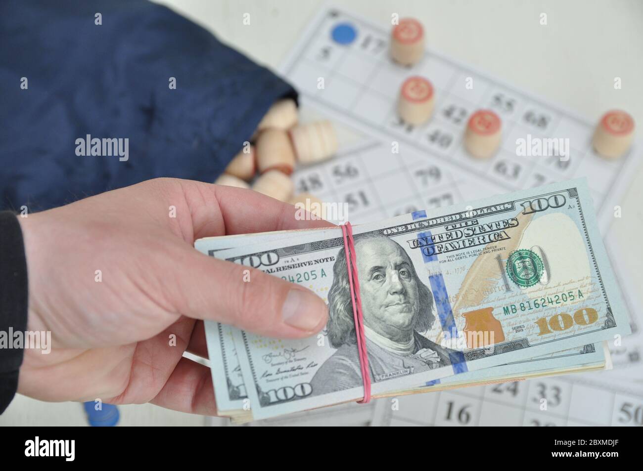 U.S. dollars. board game lotto. Wooden barrels on paper cards, a game for money. Excitement. Stock Photo