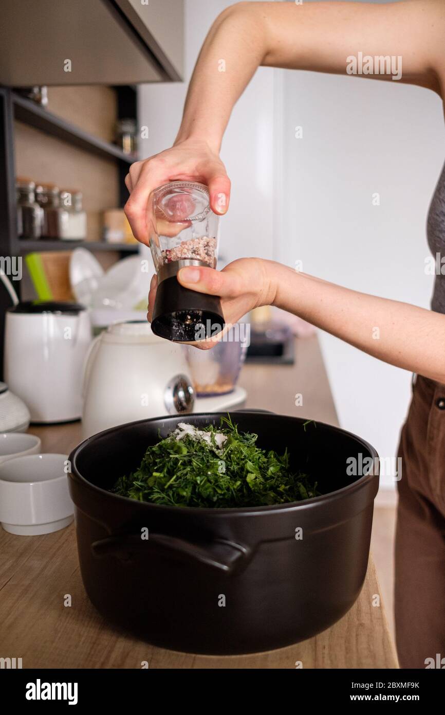 Woman Adding Salt To Food High Resolution Stock Photography and Images