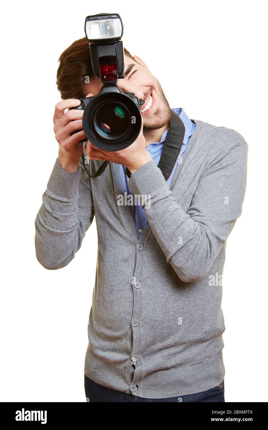 Young man photographs with a large digital camera Stock Photo