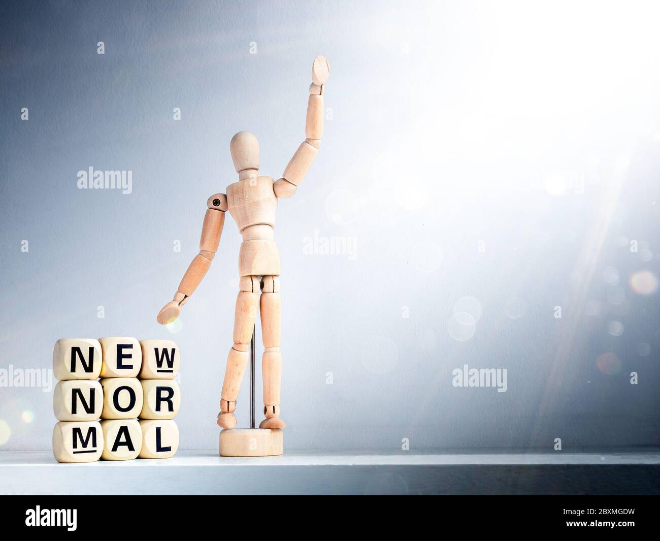 Sparkly Normal New Normal, words on wooden alphabet cube and wooden figure raising up ...