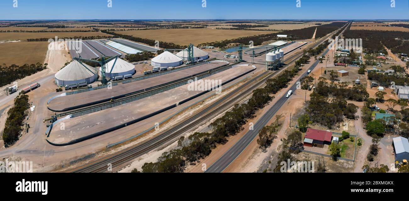 Aerial panoramic view of the small town of Grass Patch in Western Australia with the large grain silos located next to Coolgardie-Esperance Highway Stock Photo