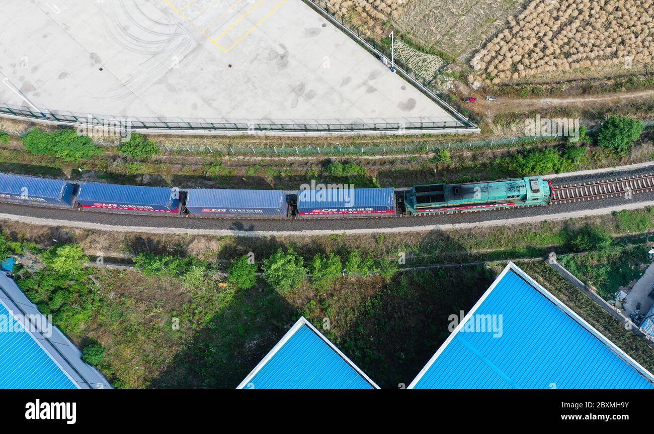(200608) -- BEIJING, June 8, 2020 (Xinhua) -- Aerial photo taken on May 26, 2020 shows a China-Europe freight train carrying mechanical accessories, fabrics and solar photovoltaic products bound for Hanoi of Vietnam leaving a logistic hub in Hai'an, east China's Jiangsu Province.  Initiated in 2011, the China-Europe rail transport service is considered a significant part of the Belt and Road Initiative to boost trade between China and countries participating in the program.  Amid the coronavirus pandemic, the service remained a reliable transportation channel as air, sea and road transportatio Stock Photo