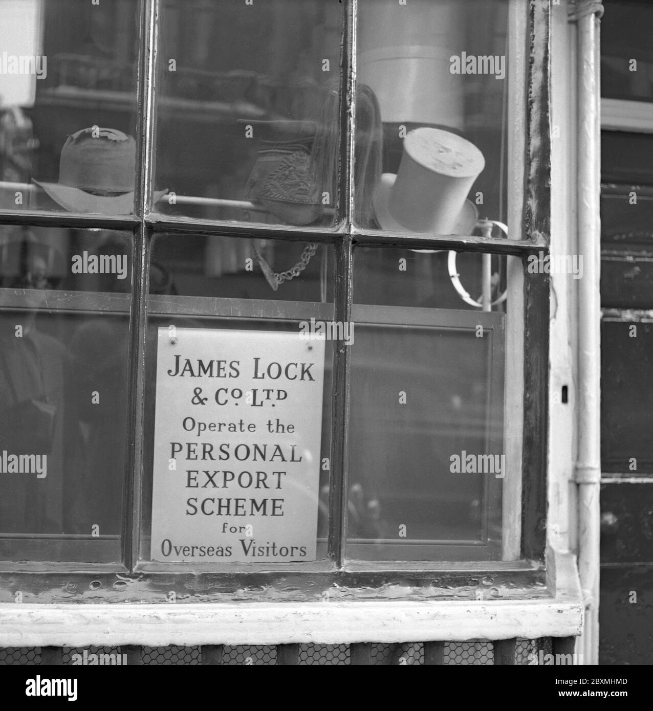 London in the 1950s. James Lock & Co.  is the world's oldest hat shop, the world's 34th oldest family-owned business and is a Royal warrant holder. Its shop is located at 6 St James's Street, London and is a Grade II* listed building. Stock Photo