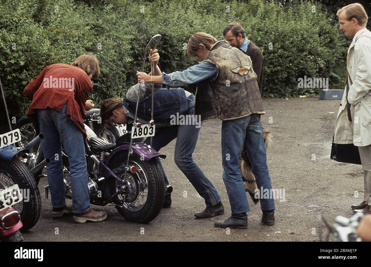 In the 1960s. Motorcyclists with their bikes. Cool and trendy looking wearing the fashion typical for the time of the 1960s. The law of wearing a safety helmet is not yet in force and at this time it was popular to wear caps. Sweden 1968. ref CV31 Stock Photo