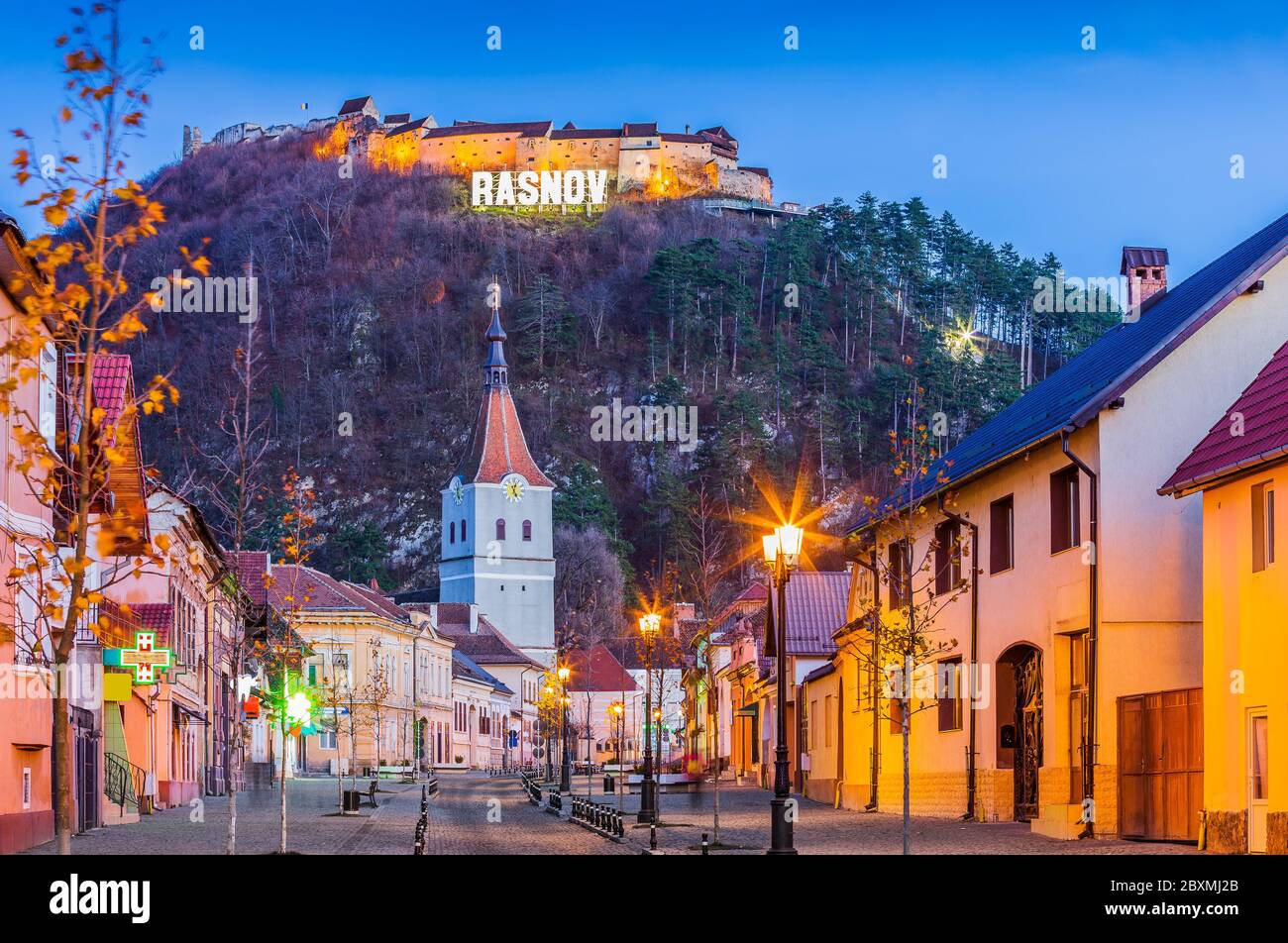 Brasov, Romania. Downtown Rasnov and hilltop fortress. Stock Photo