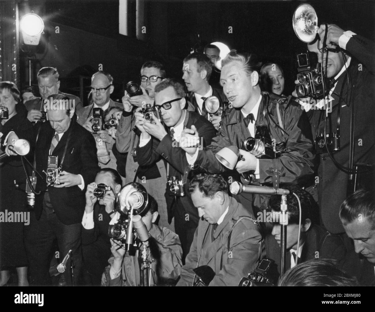Press photographers. Media is very interested in covering the wedding  of Princess Birgitta of Sweden with prince Johann Georg of Hohenzollern-Sigmaringen in Sigmaringens church may 30 1961. The pressphotographers at the event are all trying to get good pictures of the couple. Many different cameras are visible, Rolleiflex, Hasselblad, Leica. Stock Photo