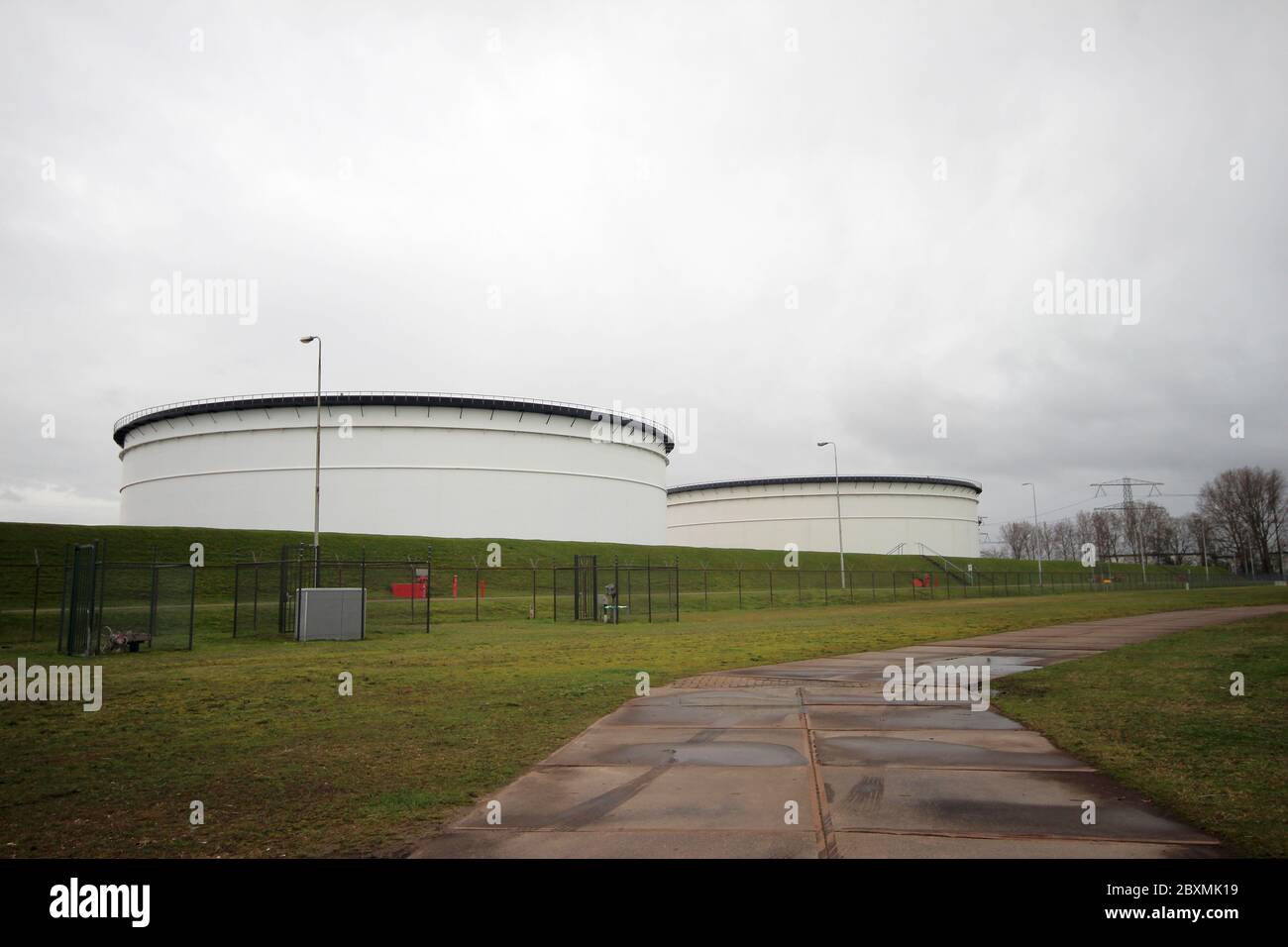 Big storage tanks for crude oil or petrol at terminal in de botlek harbor of the Port of Rotterdam Stock Photo