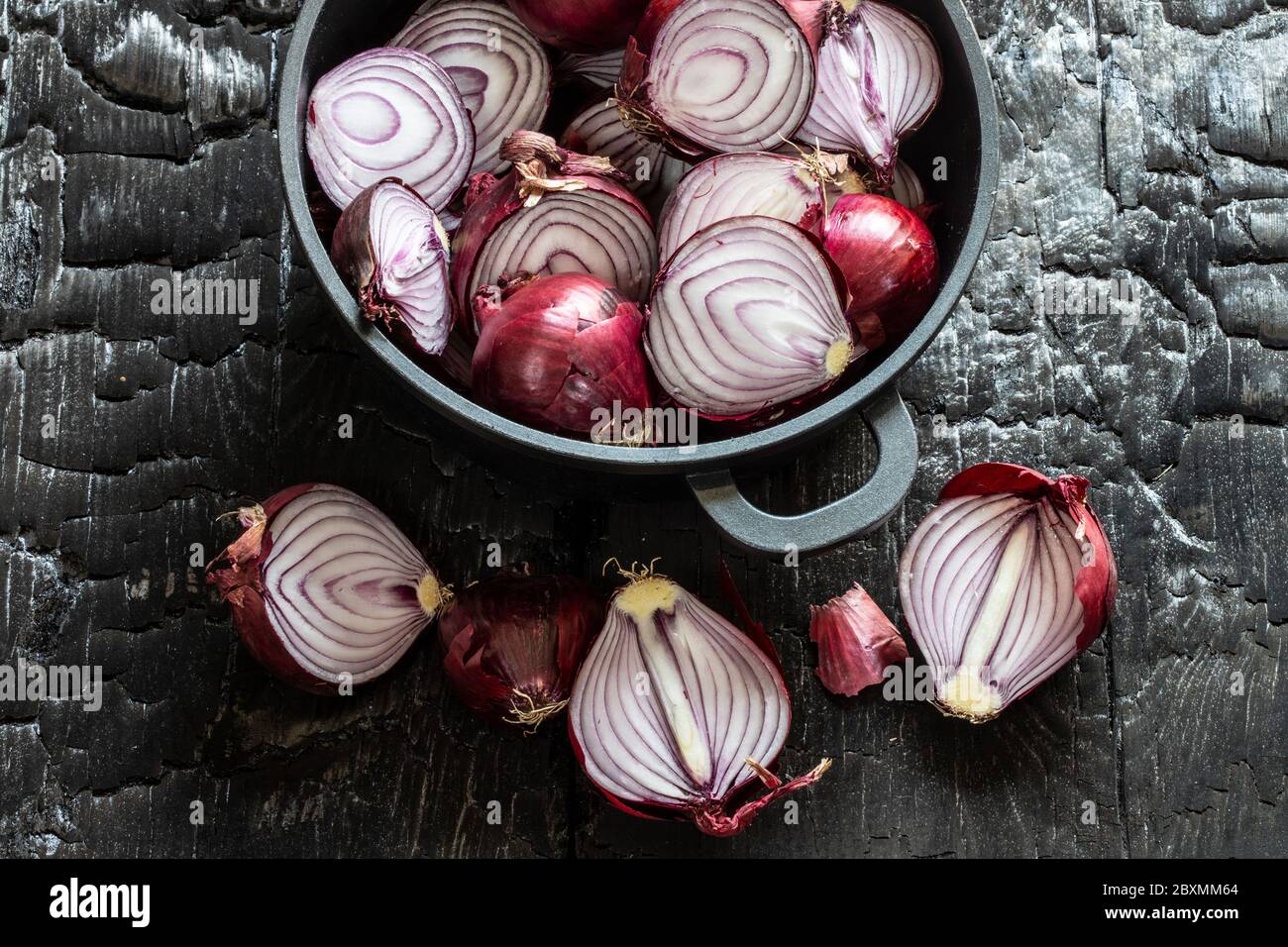 sliced red onions on black ground Stock Photo